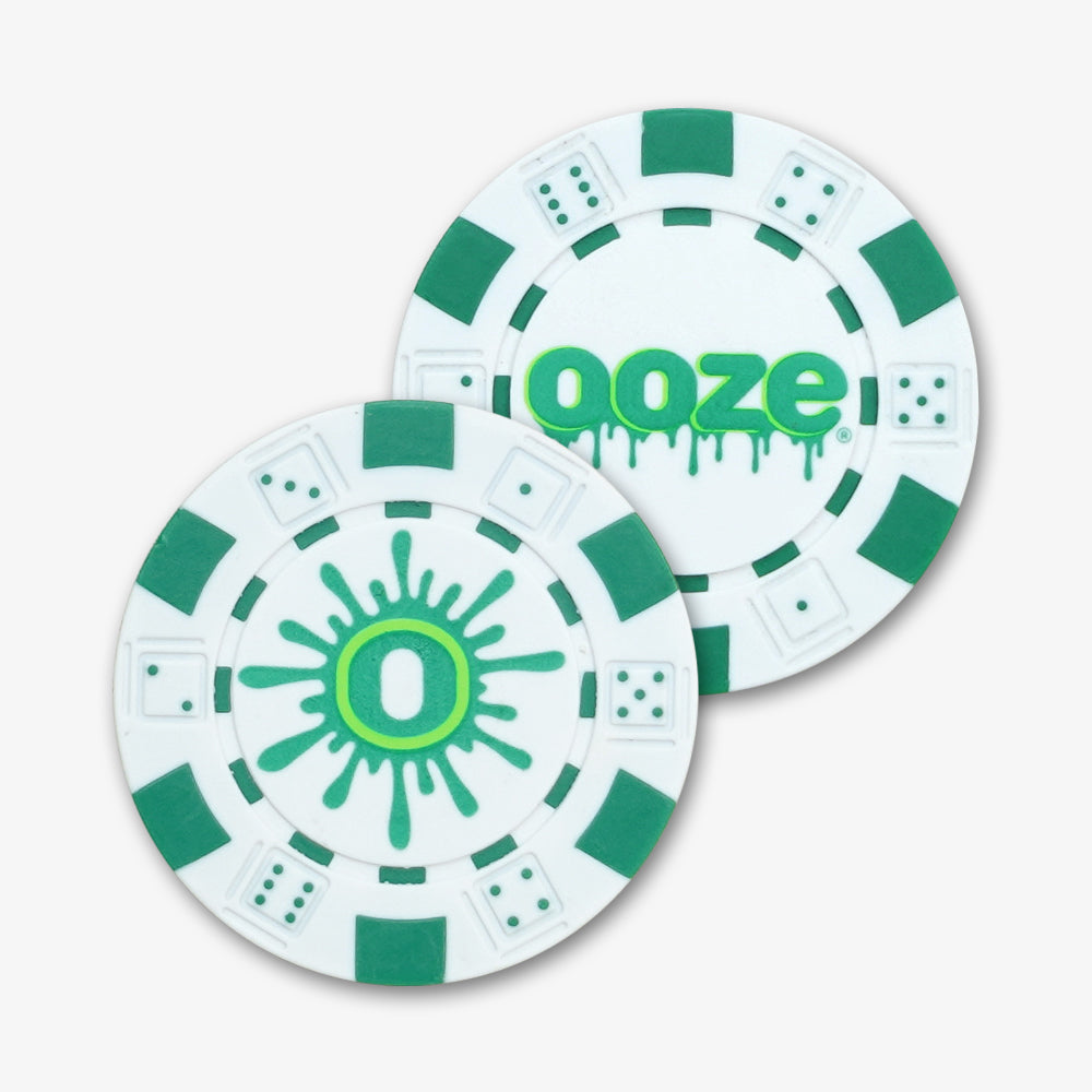 Two white and green ABS plastic poker chips with embossed dice edges and custom Ooze printed logos