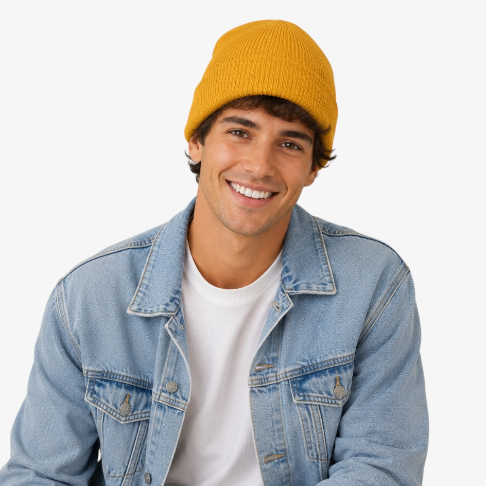 Mustard yellow acrylic beanie with ribbed knit texture and folded cuff
