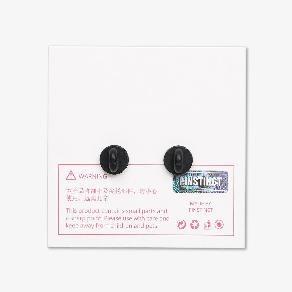White rectangular backing card with two black pin clasps and pink safety warning text