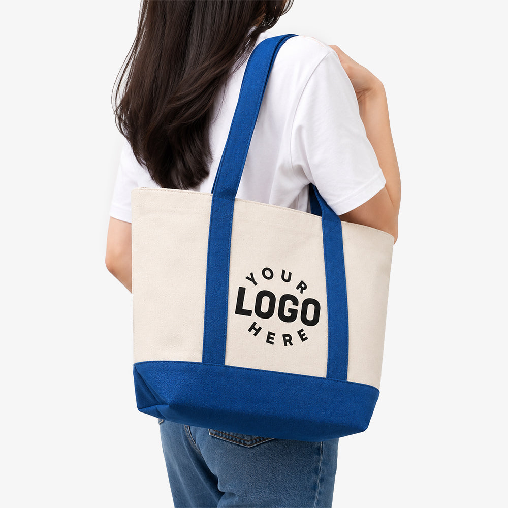 Canvas Boat Tote Bag in natural beige with blue straps and base, custom logo placeholder, carried by a woman