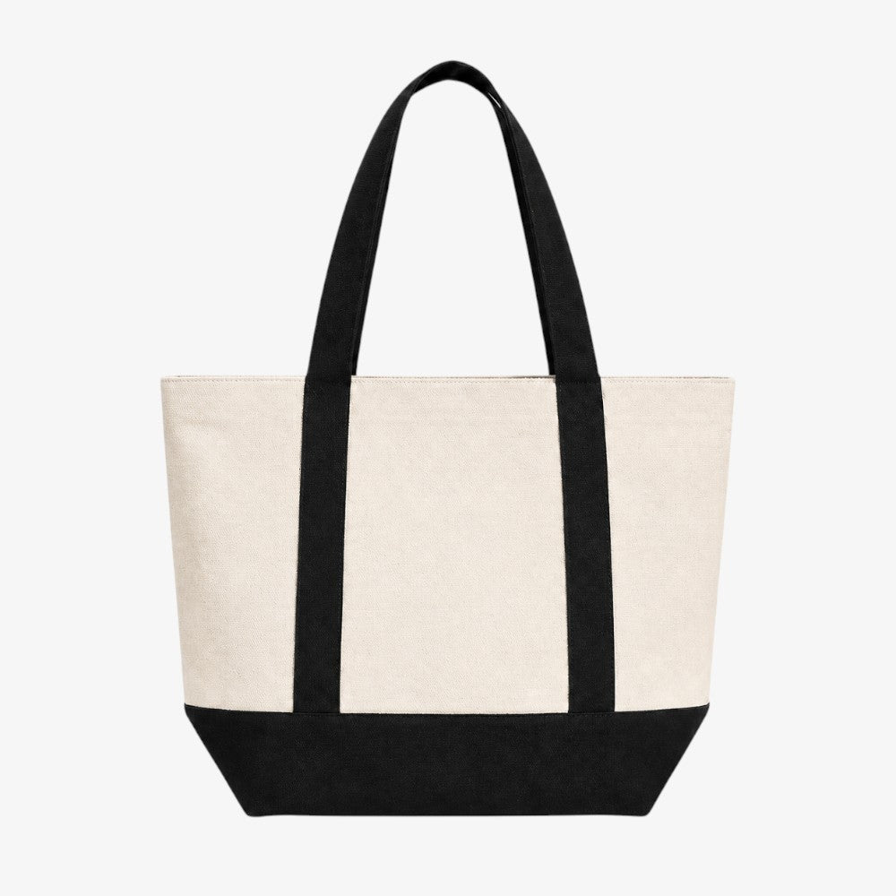 Canvas boat tote bag, two-tone off-white body with contrasting black handles and solid black bottom panel