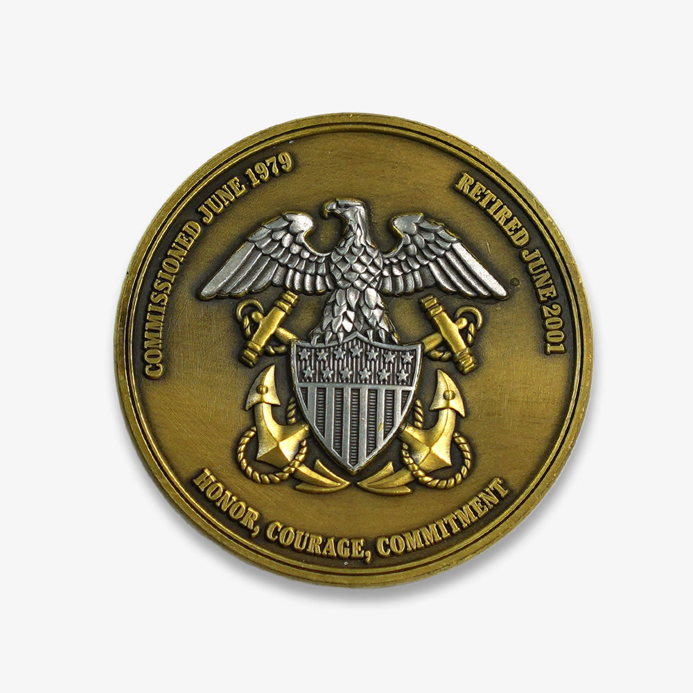 Challenge coin with antique bronze finish, embossed US Navy eagle, anchors and engraved honor courage commitment text