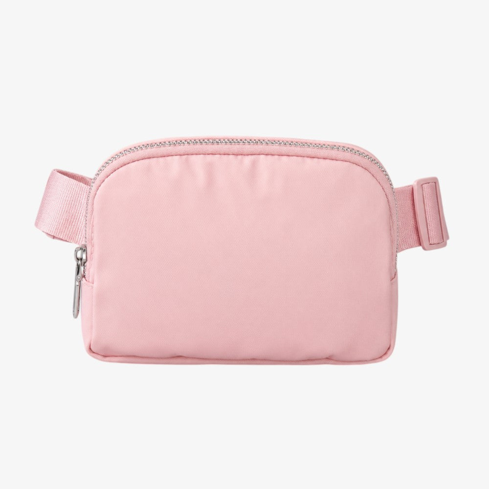 Pink crossbody fanny pack with silver zipper, adjustable strap, and rectangular padded body