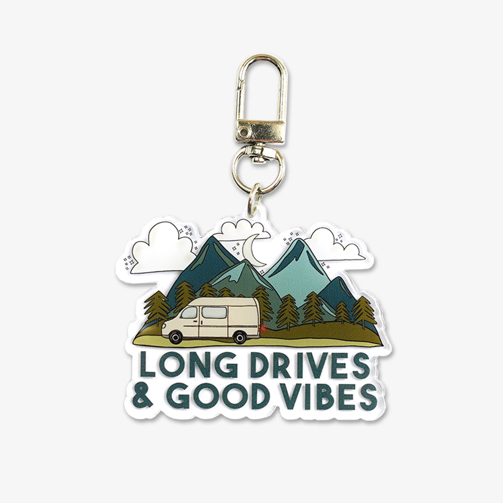 Custom acrylic keychain with camper van mountain design, printed "Long Drives & Good Vibes" text, silver metal clip