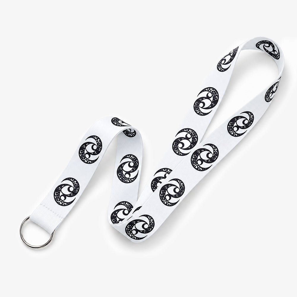White fabric lanyard with repeating black spiral patterns and a silver metal ring