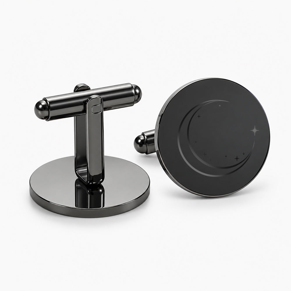 Black metal cufflinks with a polished T-bar fastener and a circular face featuring a subtle crescent and star design