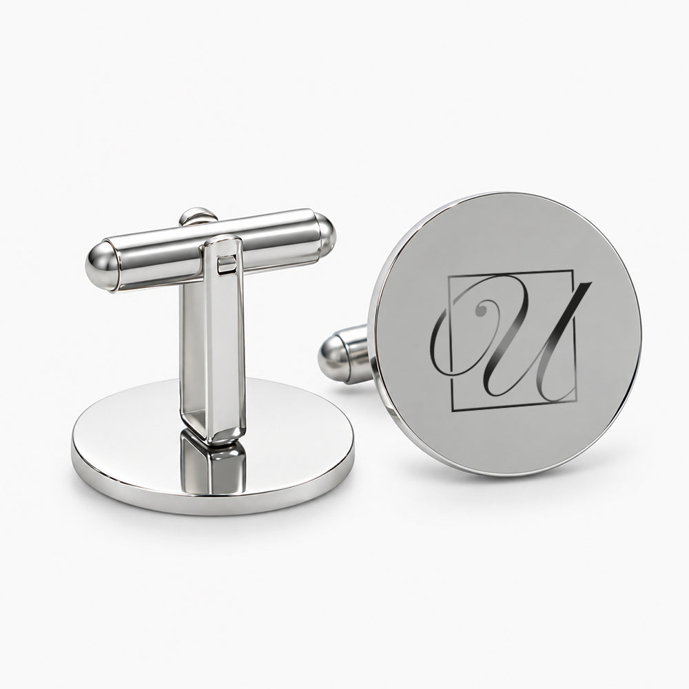 Shiny silver round cufflinks with a polished T-bar fastener and engraved monogram design
