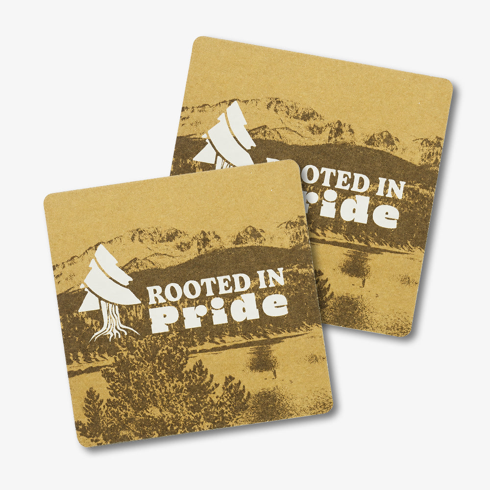 Custom Pulpboard Coasters, kraft brown square coasters printed with mountain scenery, tree graphic and "Rooted in Pride" text