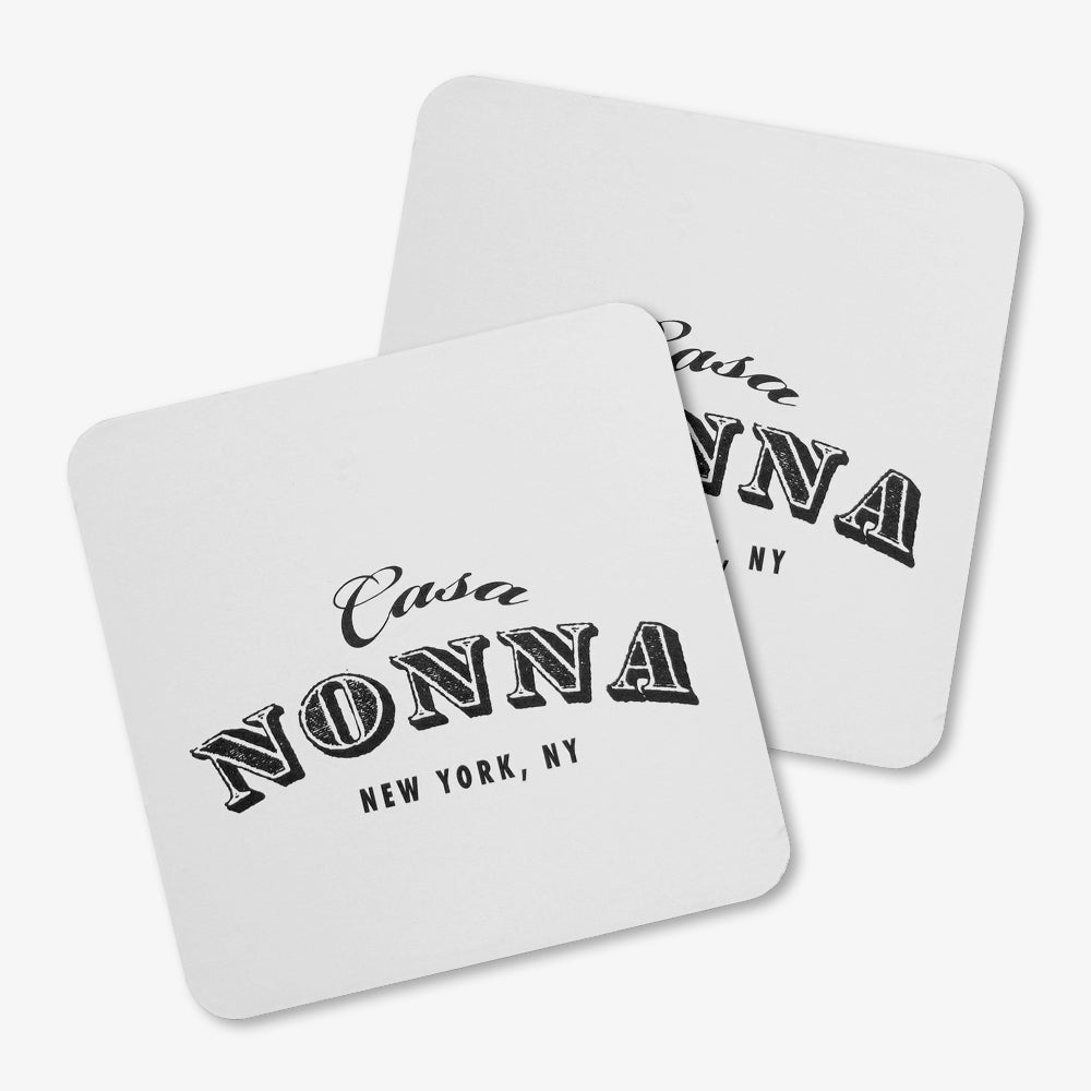 Custom pulpboard coasters, white rounded square printed with vintage "Casa Nonna New York, NY" lettering
