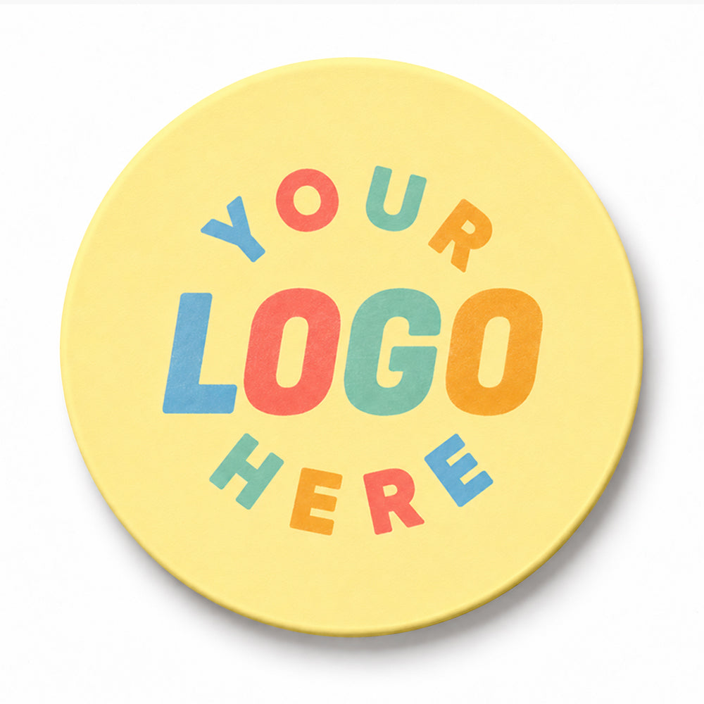 Round yellow PVC coaster with multicolored block letters arranged in a circle