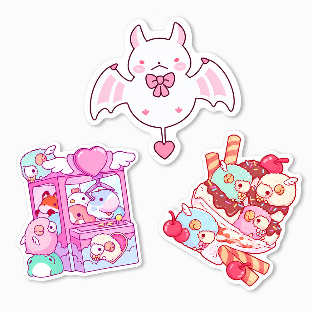 Die cut stickers featuring a pink-winged bat with a bow, a claw machine with plush toys, and a sundae with cherries and striped straws