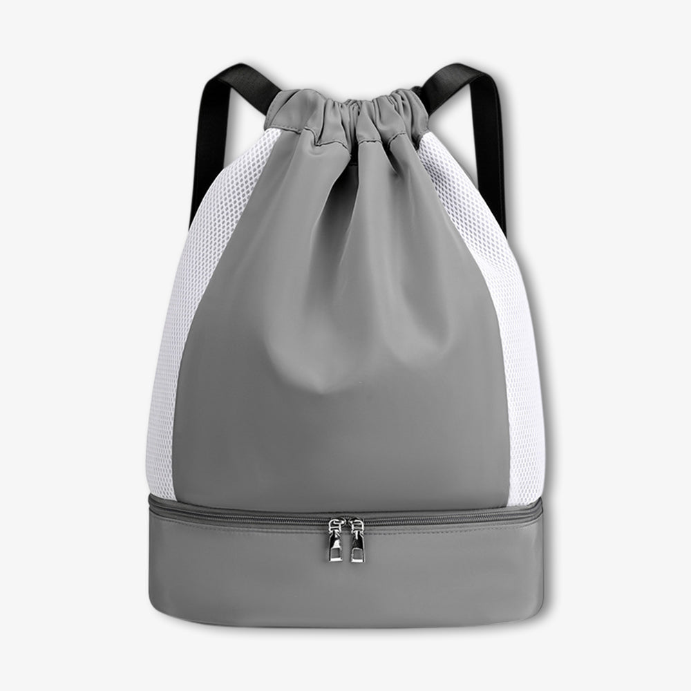 Grey drawstring sports backpack with shoe compartment, breathable mesh side panels, black shoulder straps and bottom zippered pocket