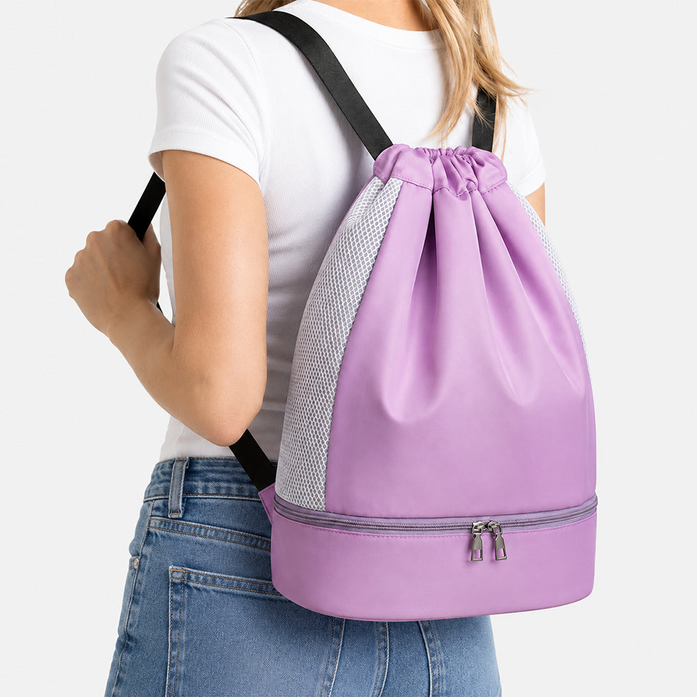 Drawstring sports backpack with shoe compartment, light purple with mesh side panels, worn by a woman
