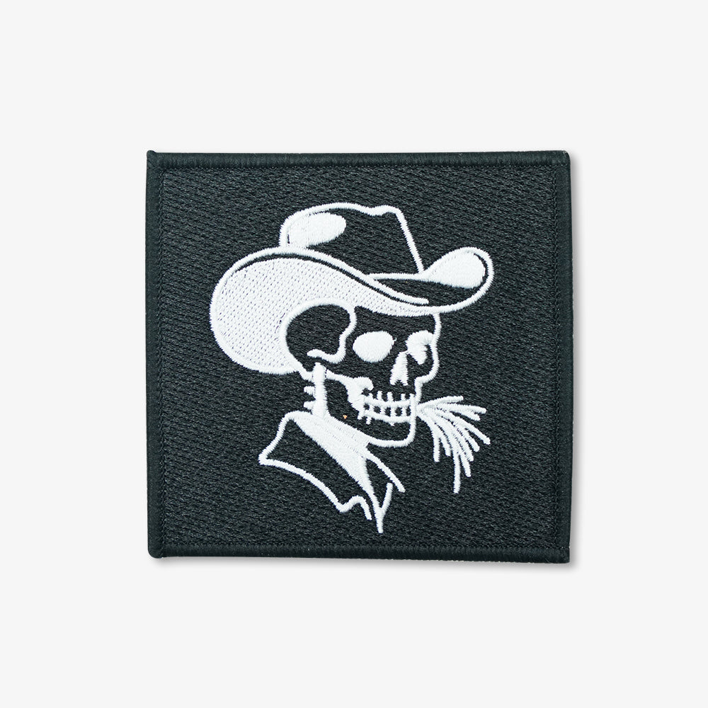 Embroidered patch, black square with white stitched cowboy skull wearing a cowboy hat design