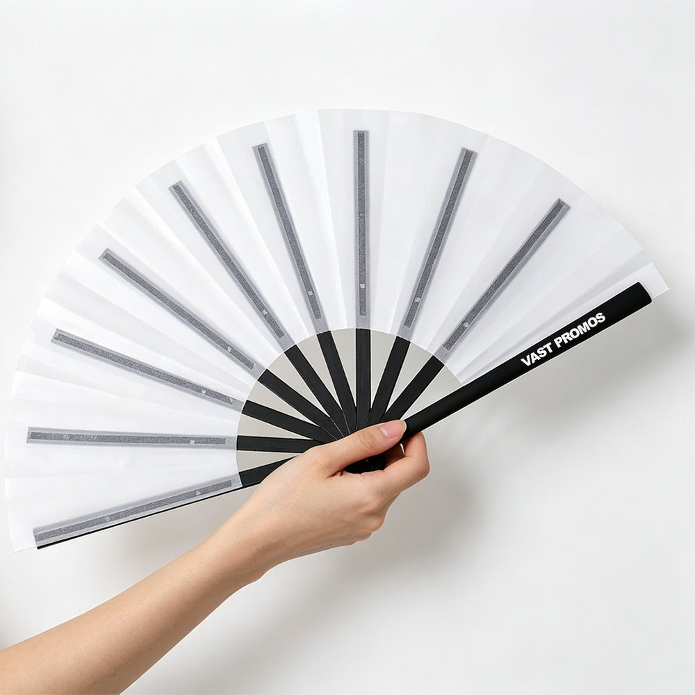 Fabric clack fan with white translucent surface and black branded handle, held by a hand against plain white background