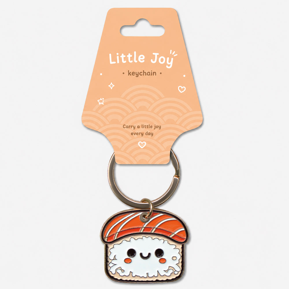 Sushi-shaped enamel keychain with orange topping, white rice base, and smiling face attached to a metal ring