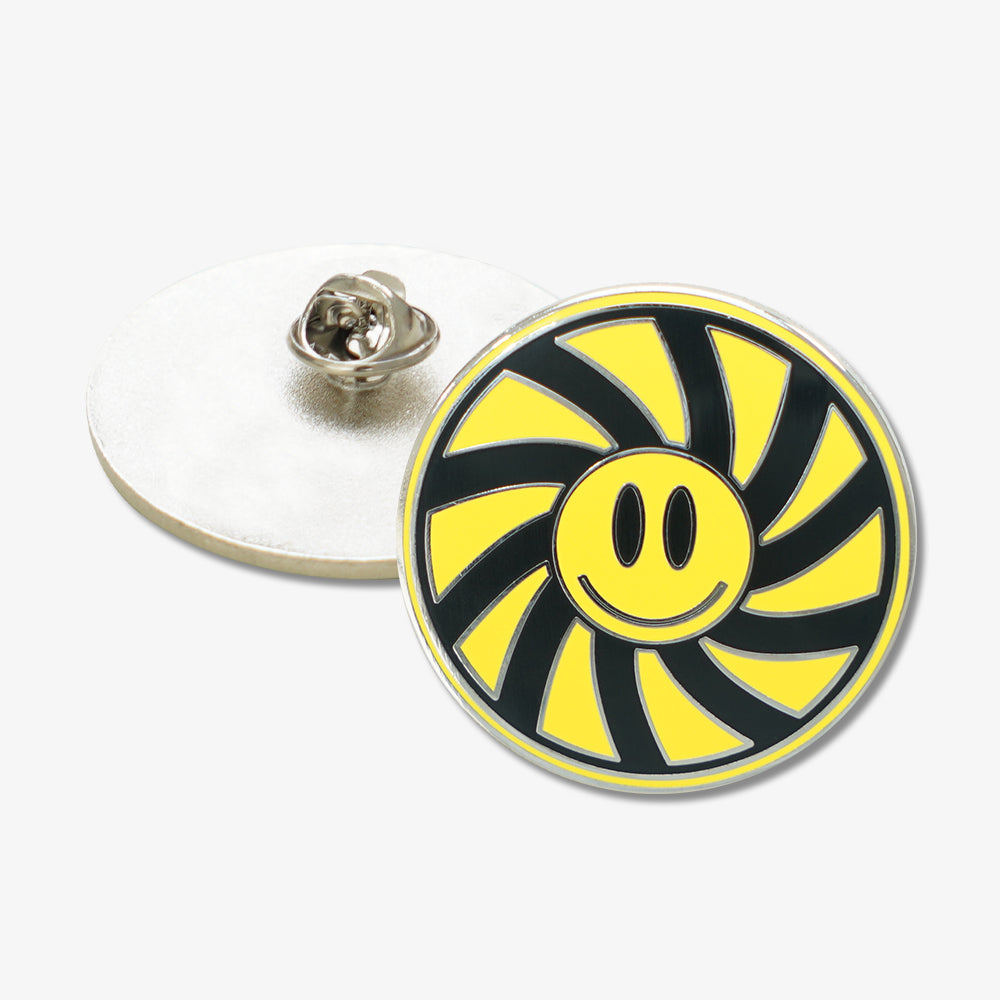Hard enamel pin featuring yellow smiley face, black and yellow swirl pattern, with metal butterfly clutch backing