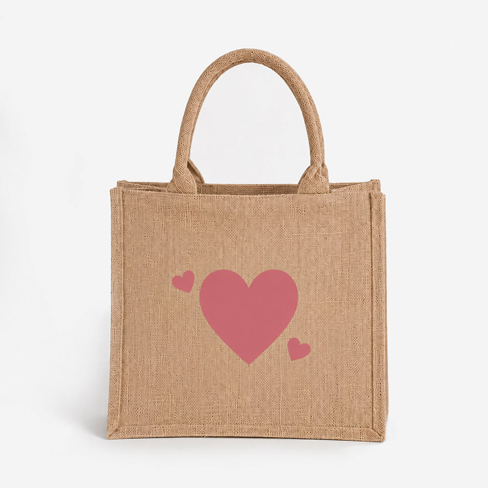 Jute tote bag in natural beige woven fabric, decorated with three cute pink heart prints