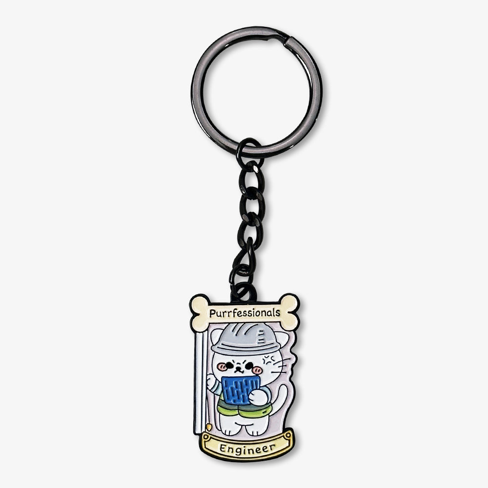Metal enamel keychain with cute cartoon engineer cat design, printed "Purrfessionals Engineer" text, attached to dark metal key ring