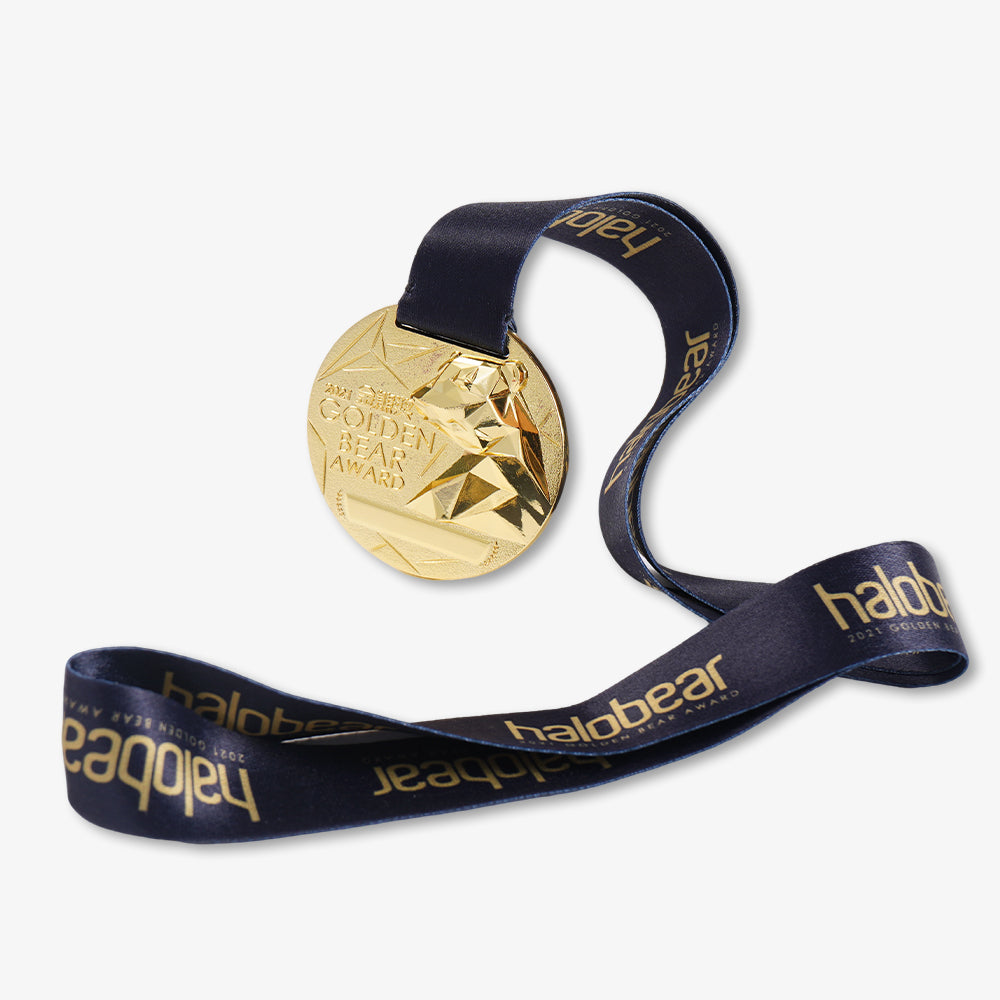 Gold metal medal with embossed Golden Bear Award design, attached to navy blue printed satin lanyard