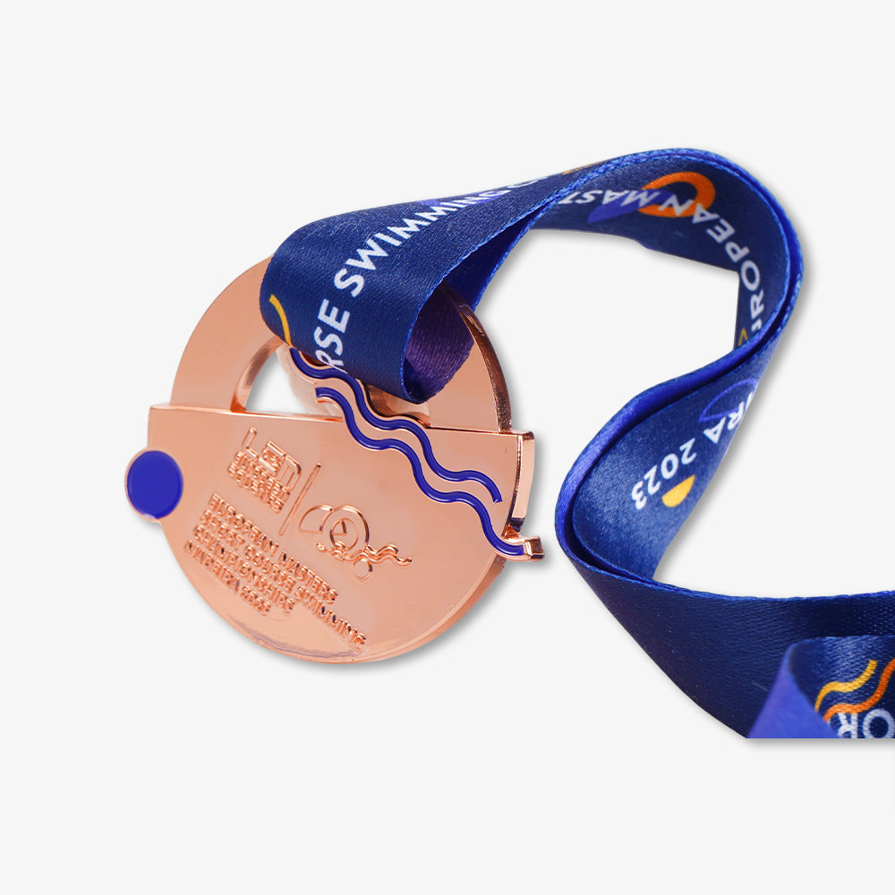 Metal swimming championship medal, rose gold finish with custom printed blue satin lanyard, engraved event text and enamel decorative accents