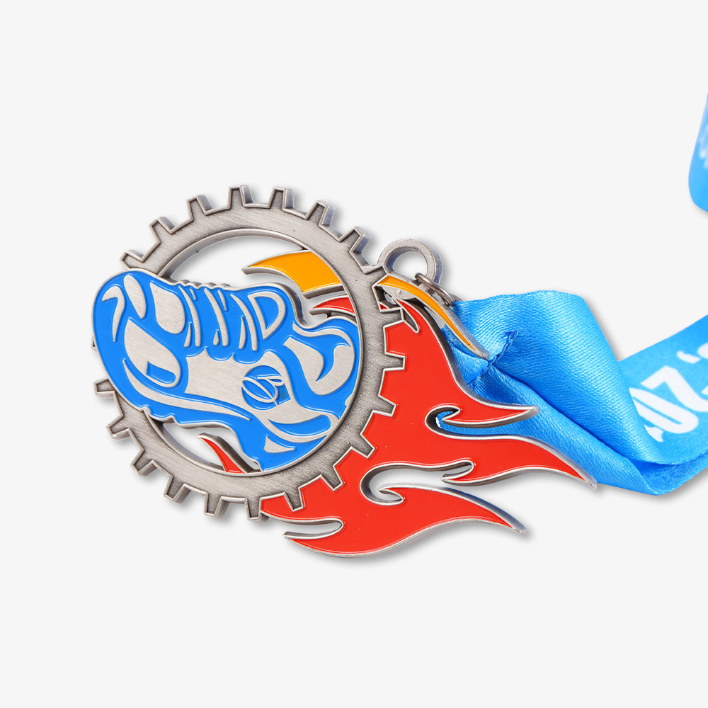 Metal medal with gear border, racing helmet and flame enamel design, attached with blue satin lanyard