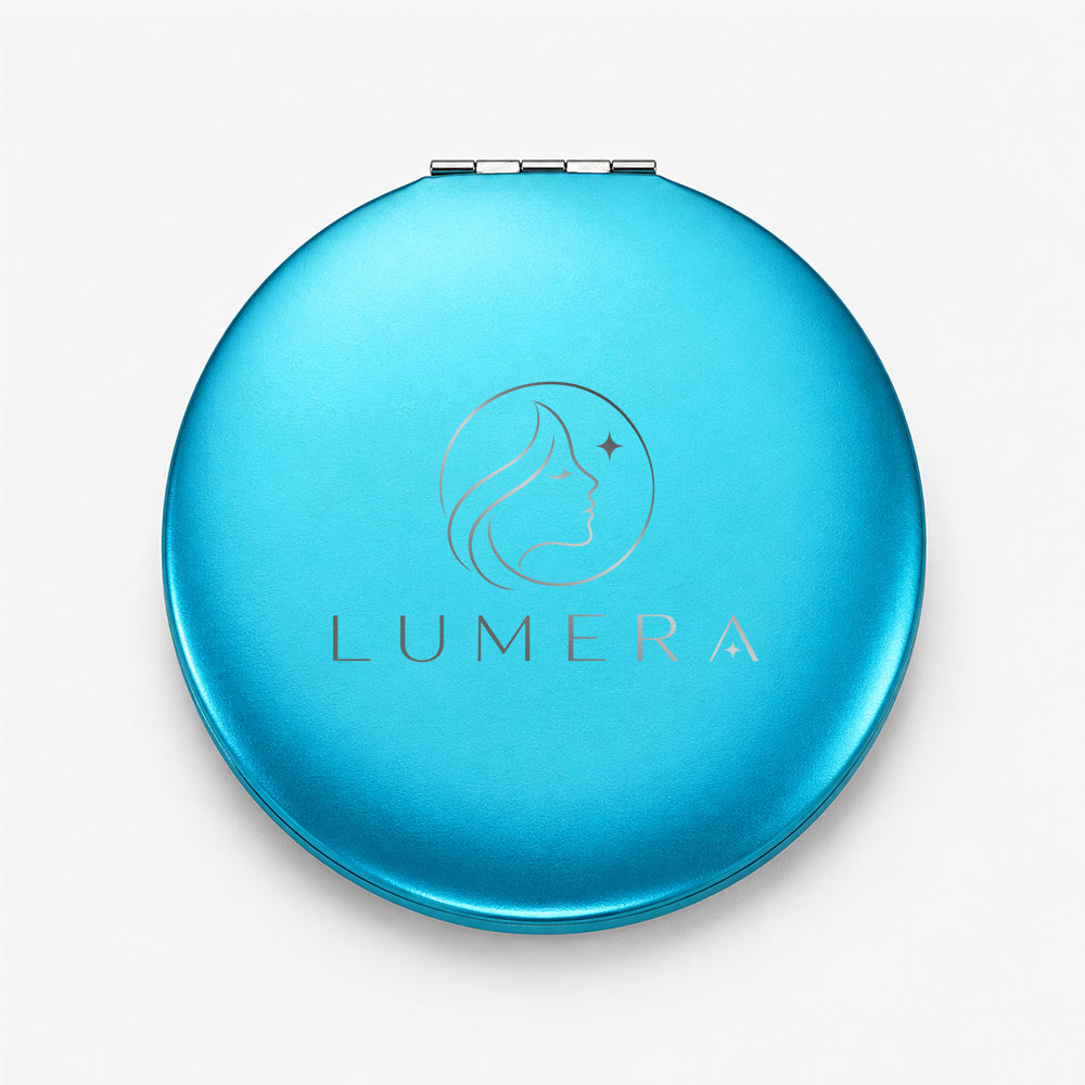 Compact round aluminum mirror in vibrant turquoise with a hinged lid and subtle engraved design