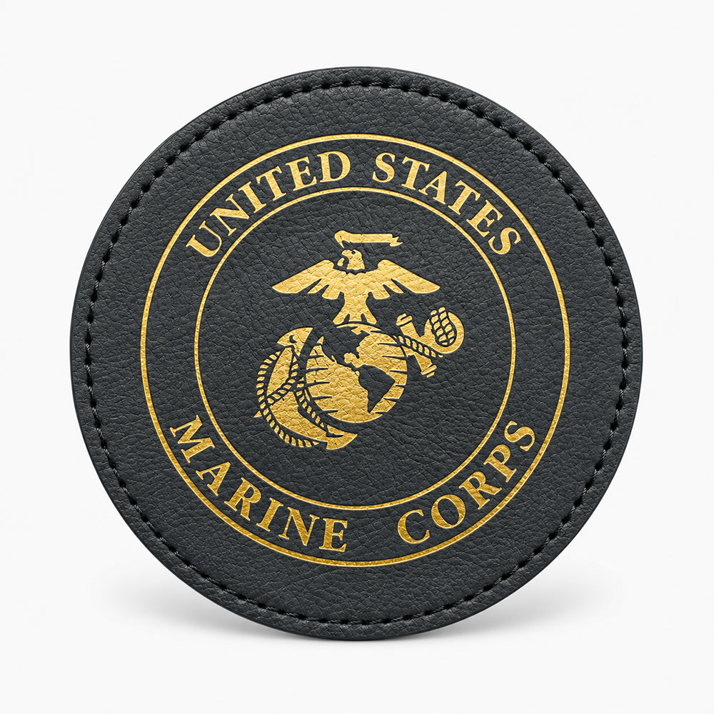 Black circular leather coaster with gold embossed emblem and stitched edge