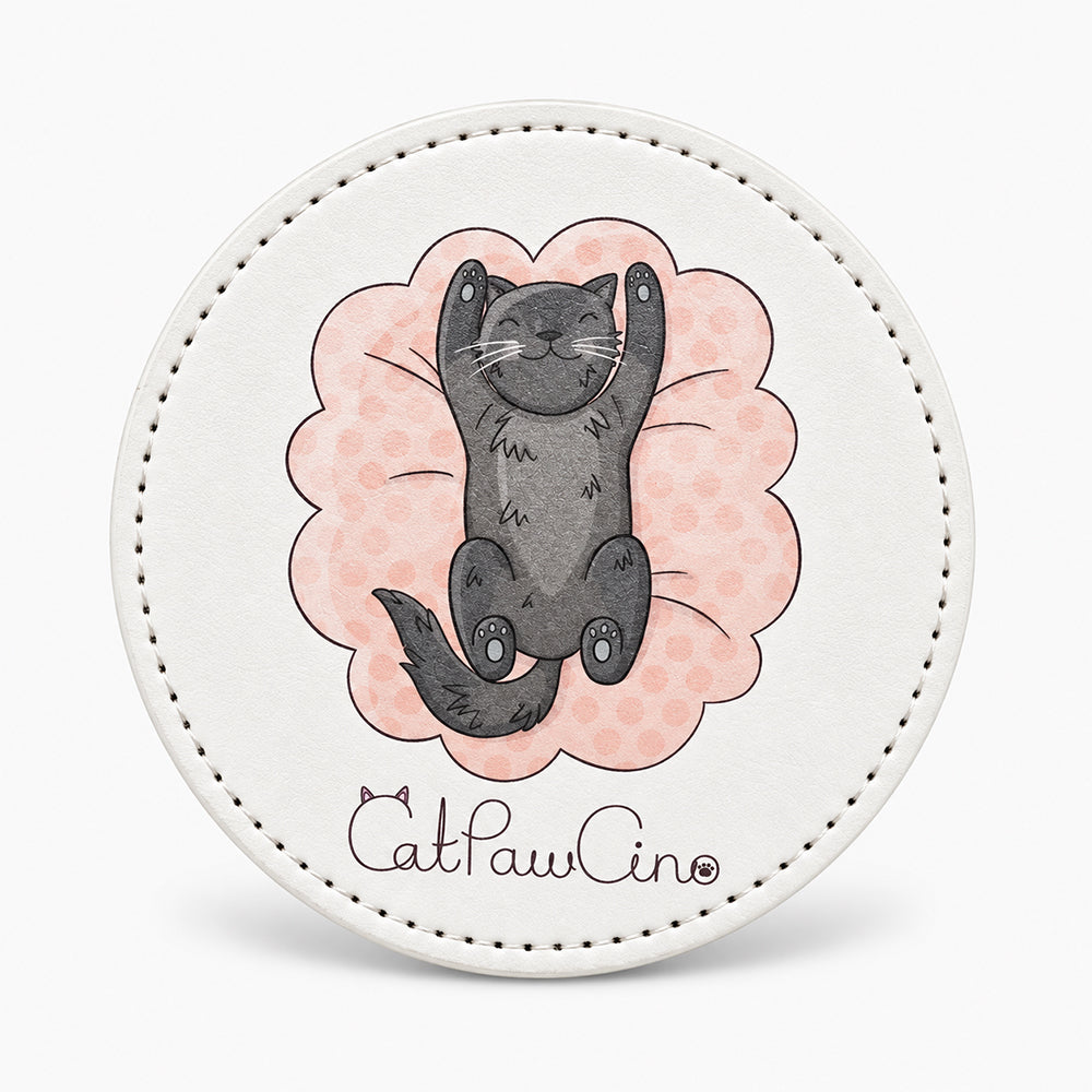 Round white leather coaster with stitched edge, featuring a gray cat illustration on a pink scalloped background
