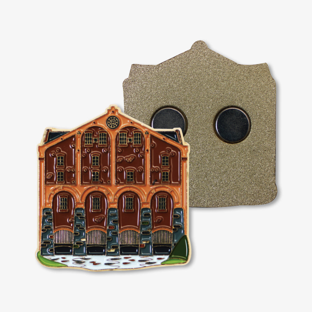 Premium metal fridge magnet in vintage brick house enamel design, displaying decorative front and magnetic back