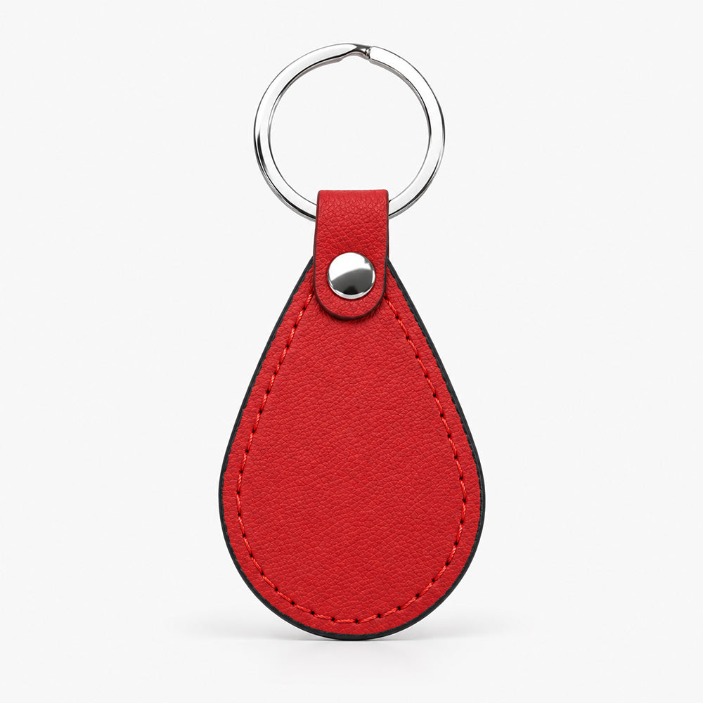 Red teardrop-shaped PU leather keychain with black edge stitching and a silver snap fastener