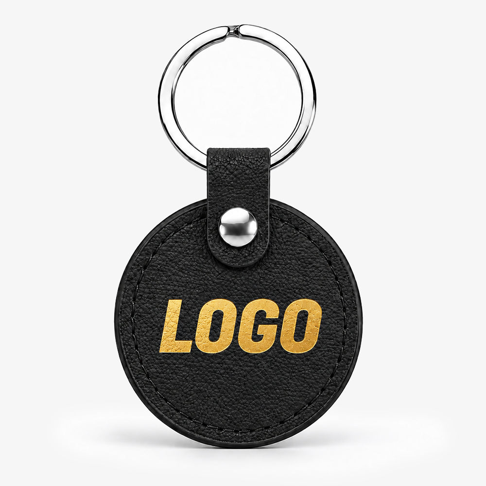 Black circular PU leather keychain with gold lettering, silver ring, and snap button fastener