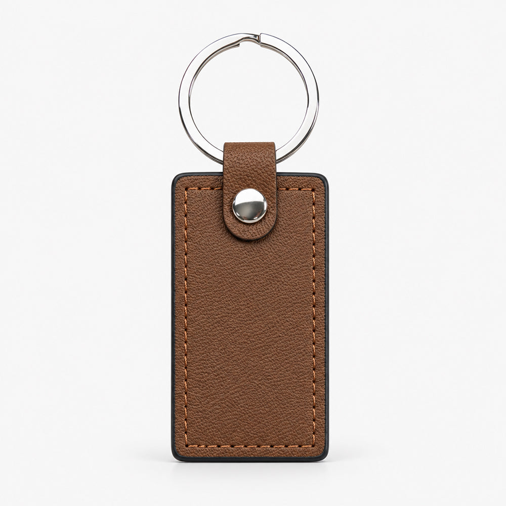 Brown PU leather keychain with silver ring, stitched edges, and snap button closure