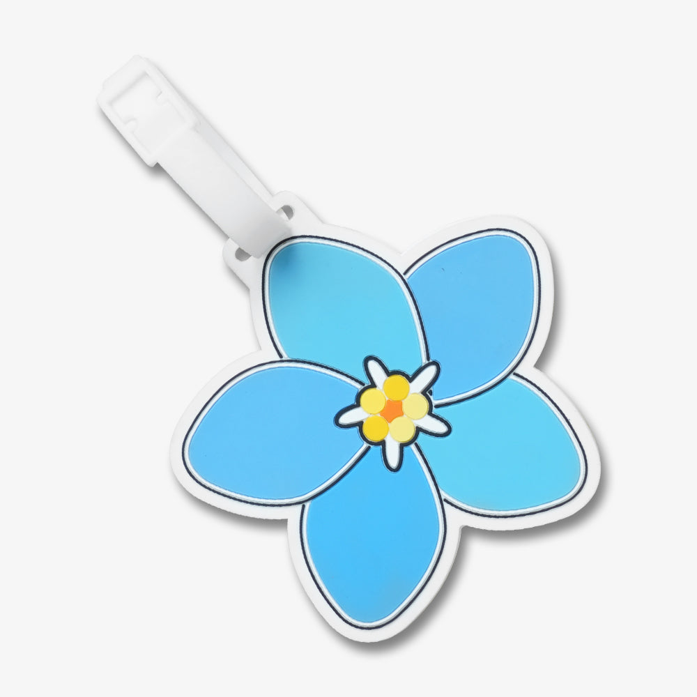 PVC luggage tag in blue plumeria flower design, with white silicone strap and bright yellow orange center details