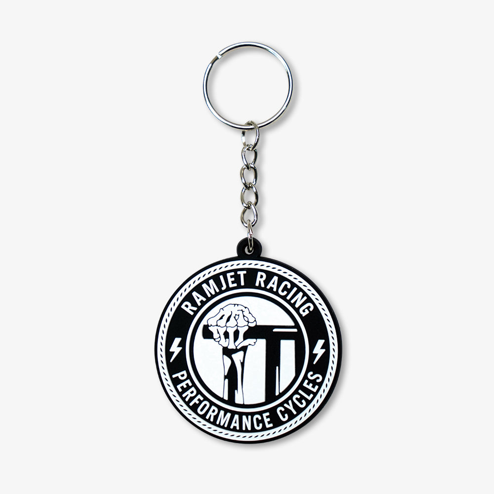 PVC Rubber Keychain with circular black and white Ramjet Racing logo, attached to silver metal key ring and short chain