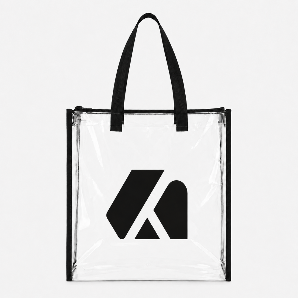 Clear PVC tote bag with black fabric handles, zipper top, and printed black geometric logo on the front
