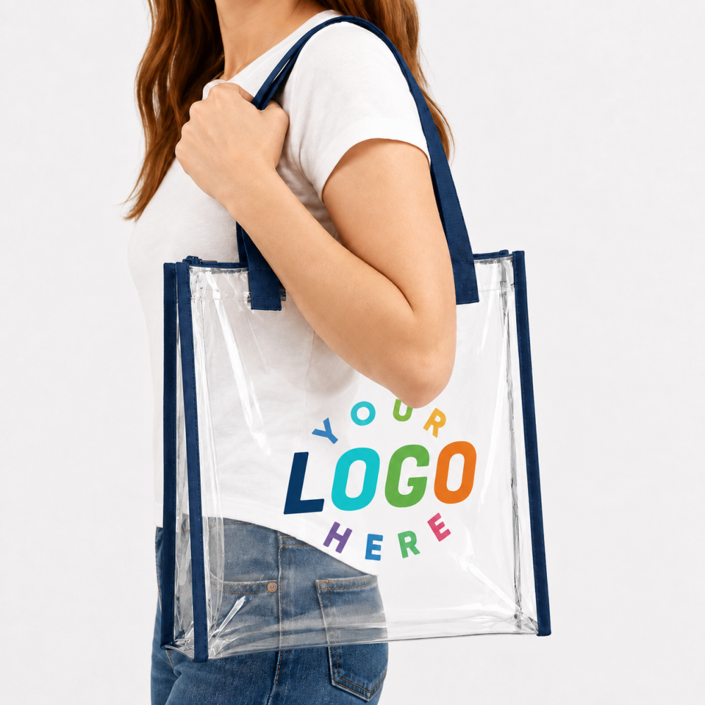 Clear PVC tote bag with navy blue straps, customizable printed logo, carried over a woman's shoulder