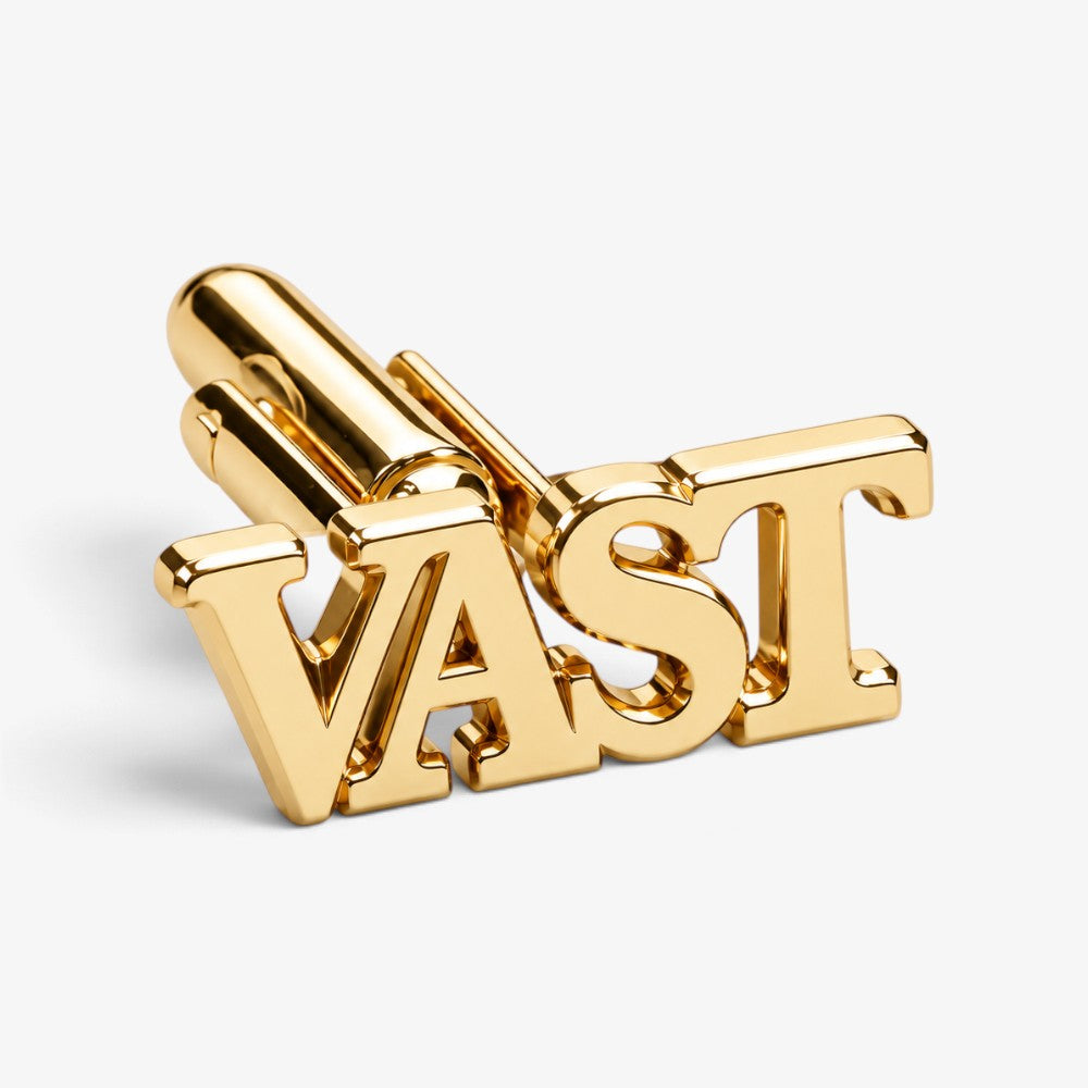 Gold-tone letter-shaped cufflinks with raised block letters and polished metal finish