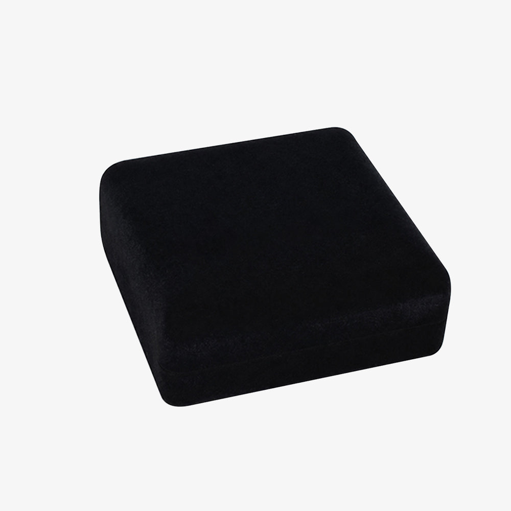 Black velvet coin box, rounded square closed design, soft plush velvet surface, isolated on plain white background